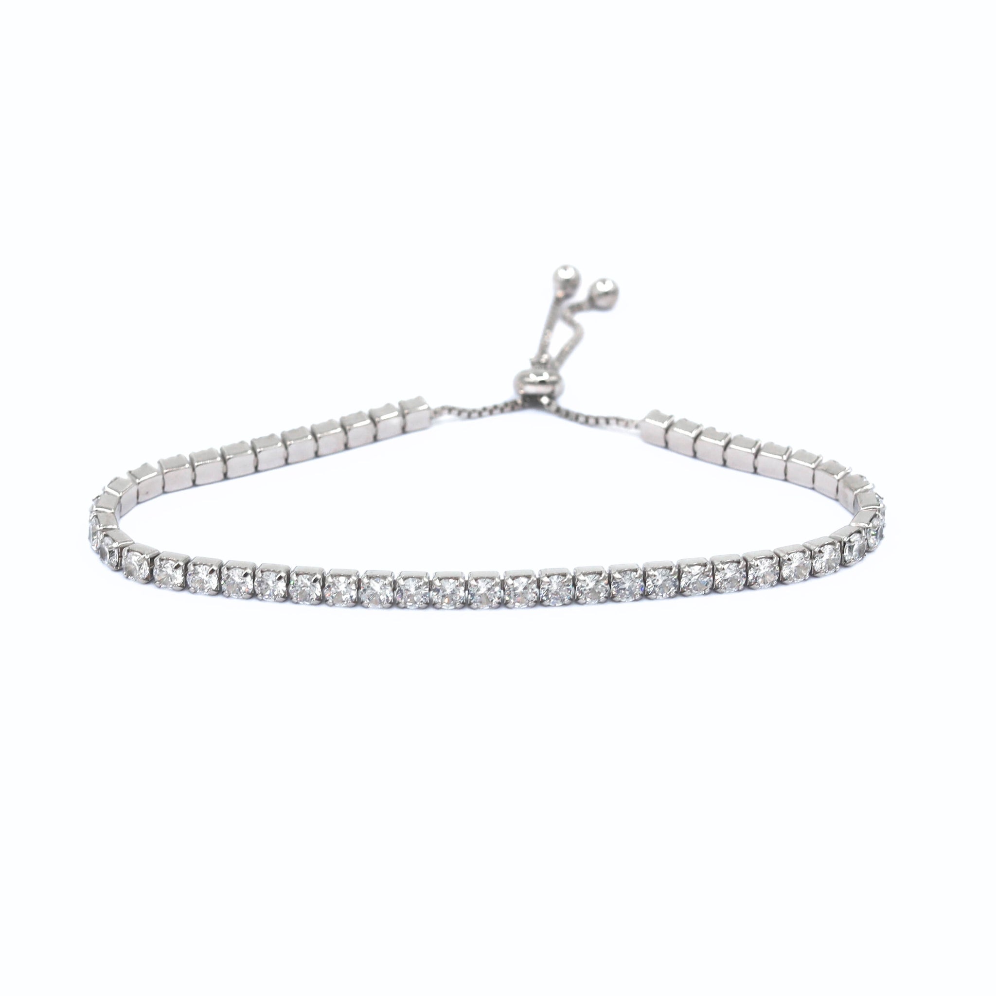 Tennis Bracelet Bijou in Silver, featuring round sparkling cubic zirconia stones set in a high-quality sterling silver band, offering a chic and elegant design for a refined look. Rhodium plated. The bracelet is adjustable so that you don't have to worry about the sizing.