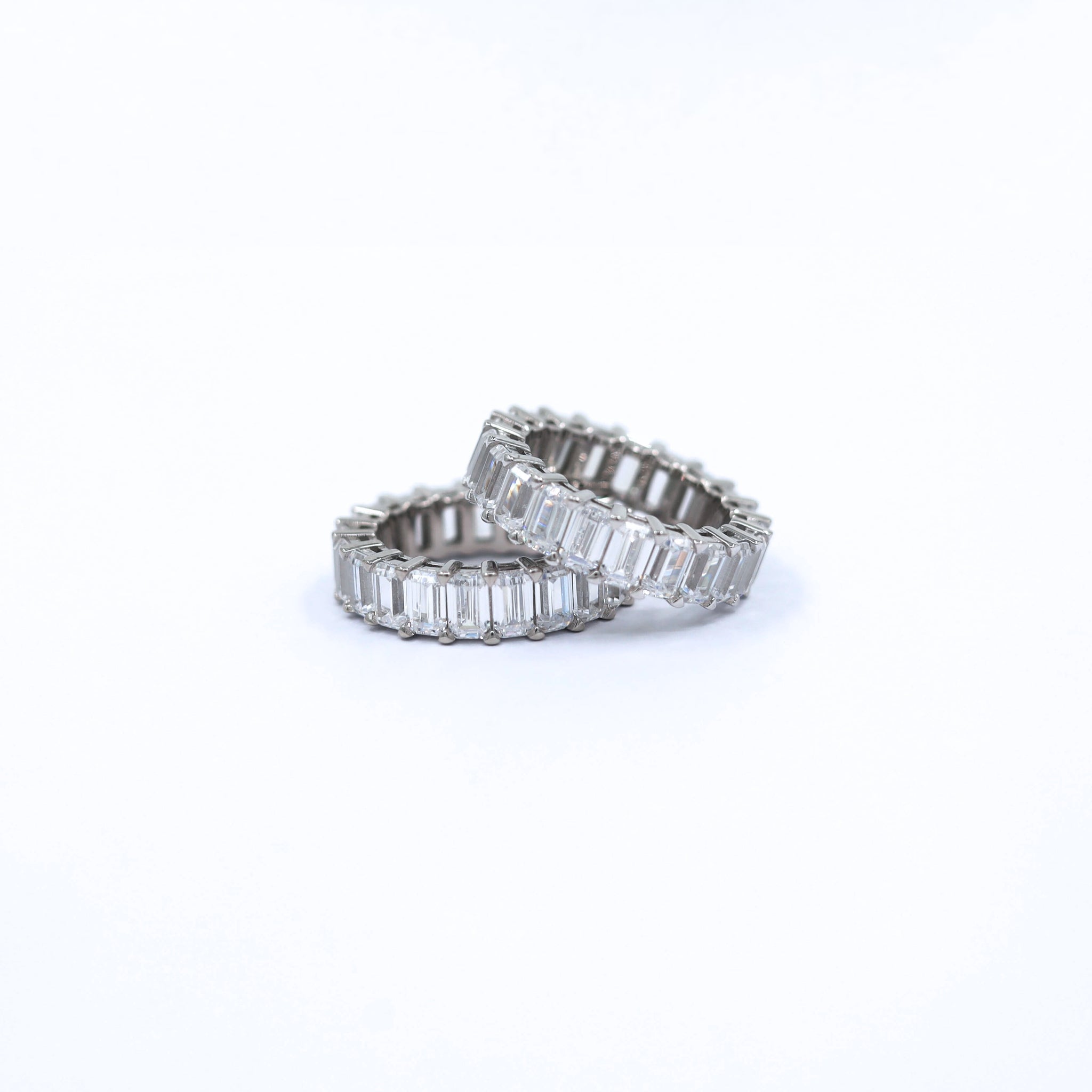 Side view of the Crystal Garden Geometric Ring in sterling silver with rhodium plating, showcasing the elegant geometric design and clear cubic zirconia stones in a contemporary setting