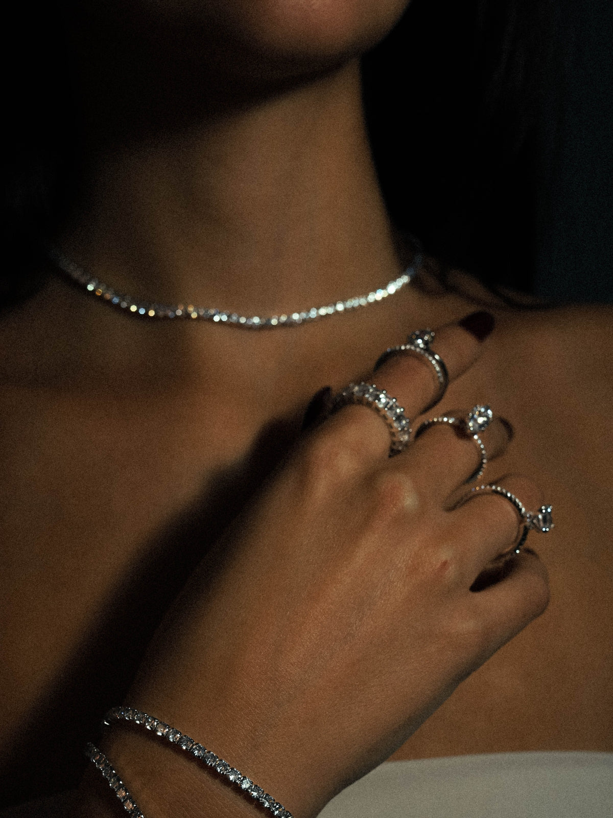 A stunning showcasing of multiple sterling silver rings and tennis necklace