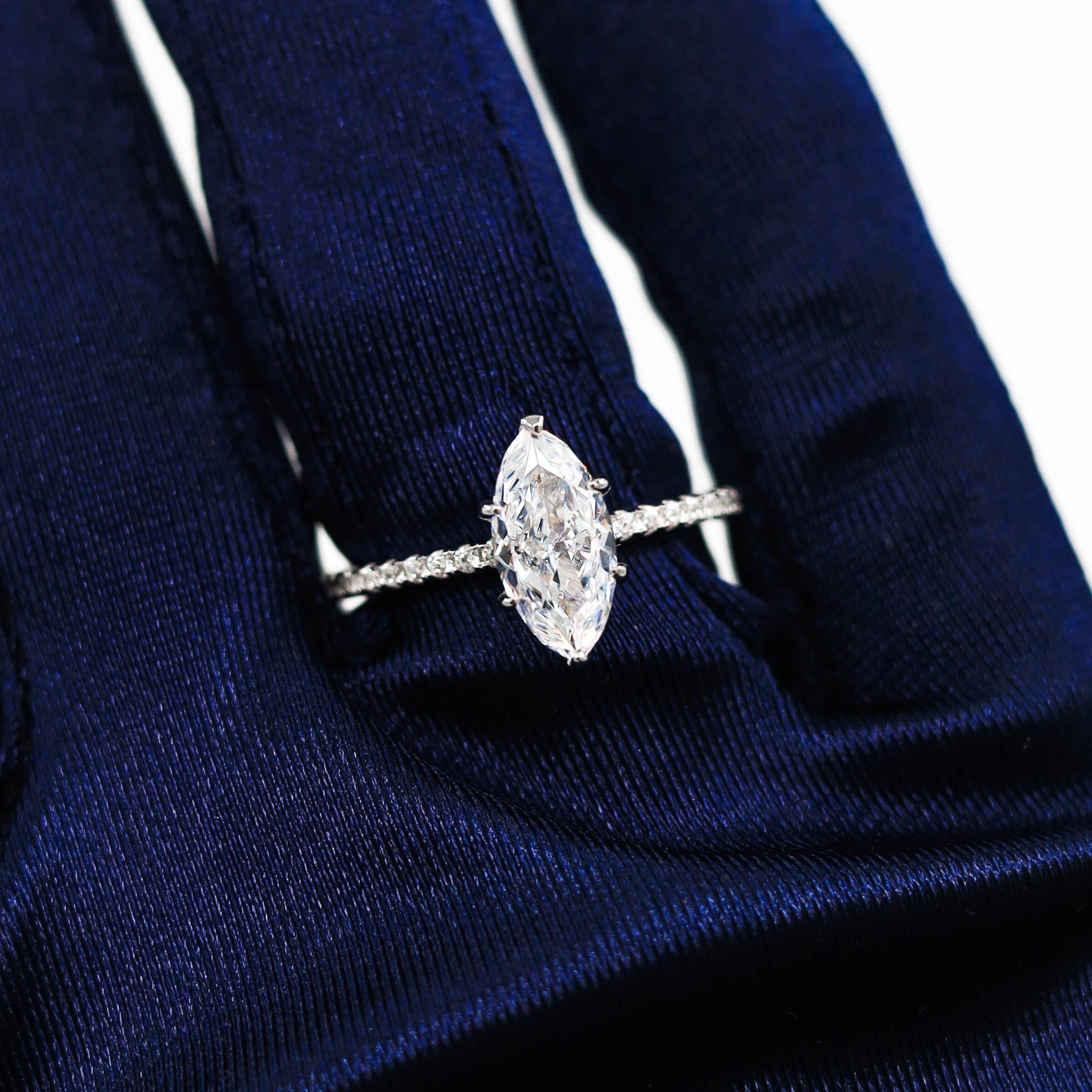 Kapi Marquise Cut Ring in Silver worn on finger, highlighting the elegant marquise-cut center stone and delicate pave cubic zirconia accents for a refined look. Rhodium plated