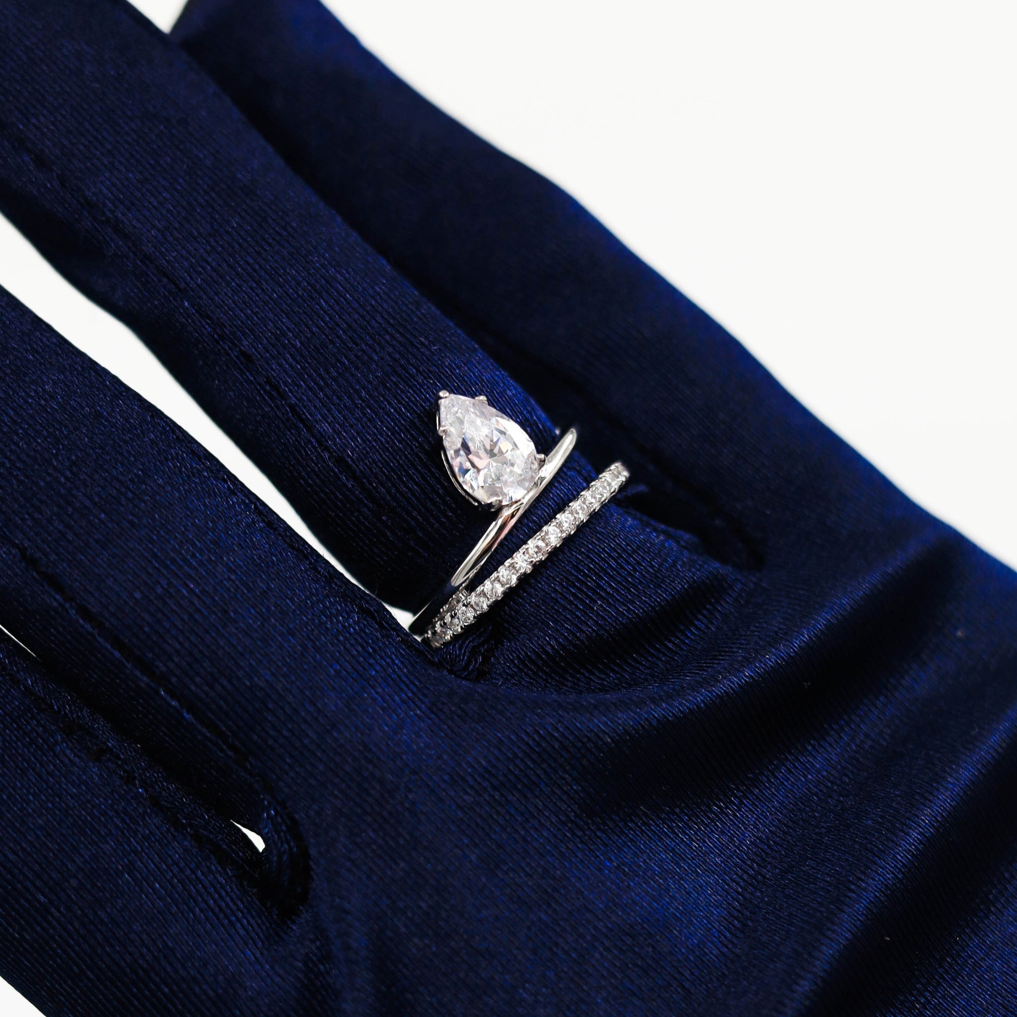 Water Drop Ring in Silver worn on the finger, showcasing the dazzling pear-shaped cubic zirconia stone set in a polished sterling silver band, perfect for special occasions. Rhodium plated.