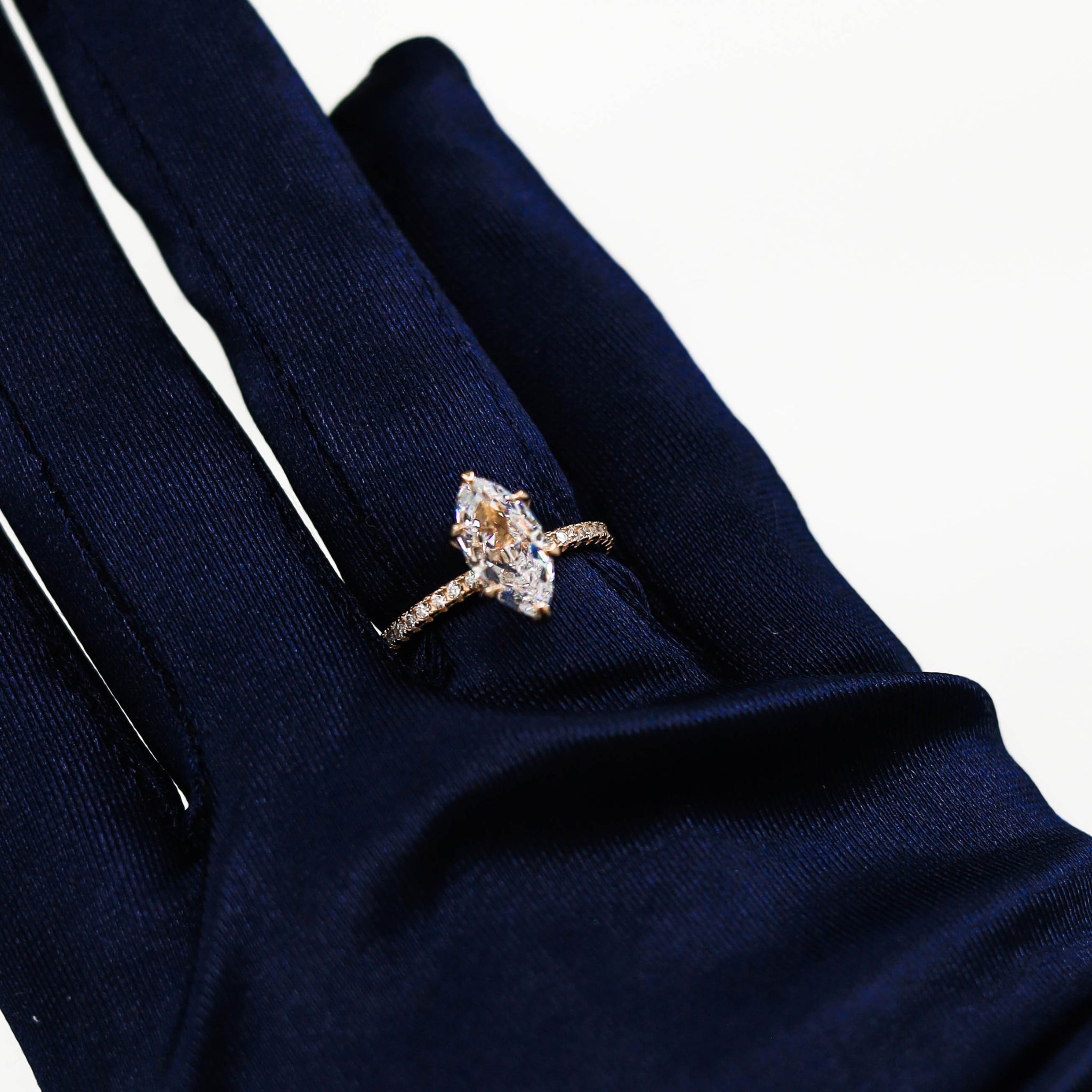 Kapi Marquise Cut Ring in Gold worn on finger, showcasing the elegant marquise-cut center stone and pave cubic zirconia details, set in gold-plated 925 sterling silver for a luxurious finish.