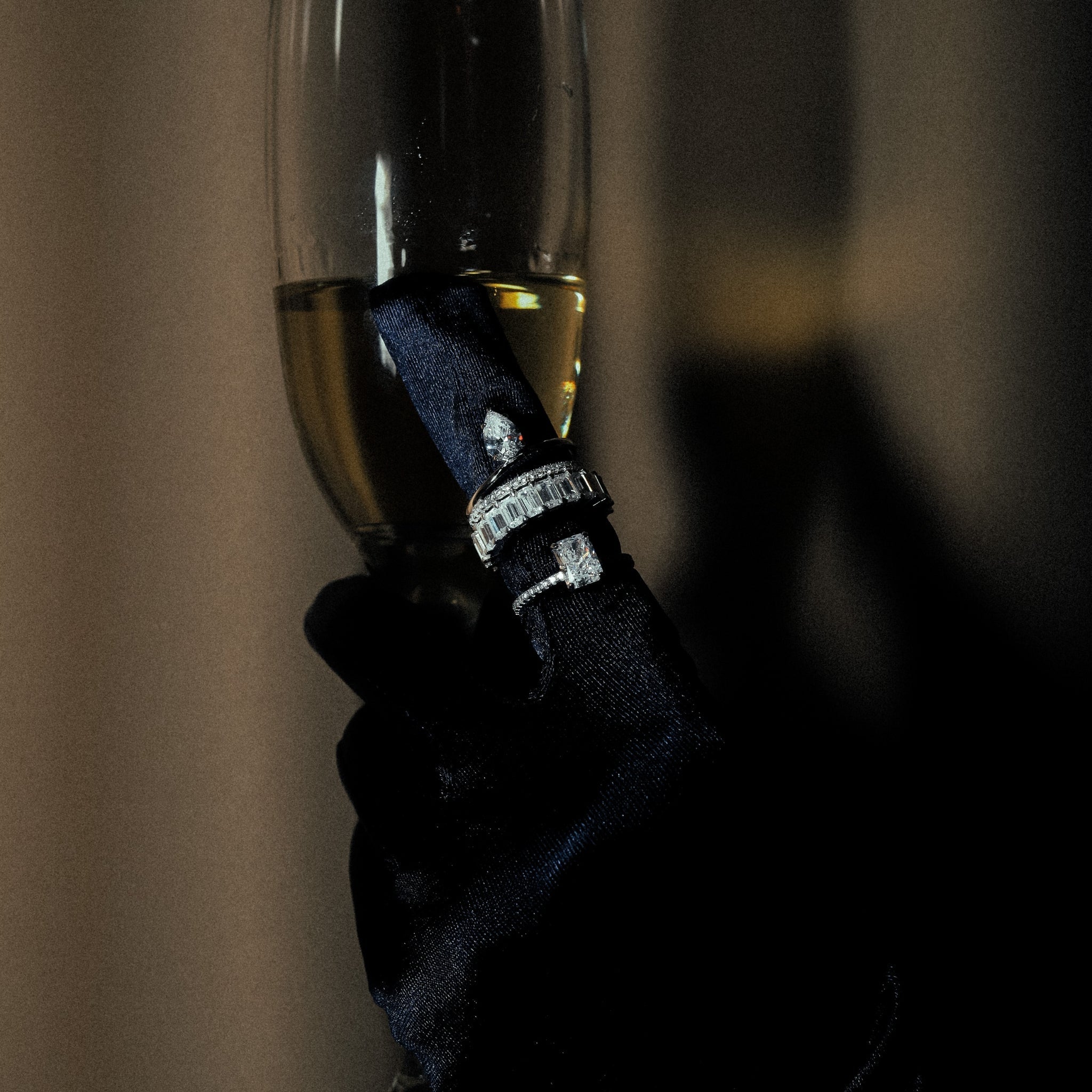 Water Drop Ring in Silver worn on the finger, showcasing the dazzling pear-shaped cubic zirconia stone set in a polished sterling silver band, perfect for special occasions. Rhodium plated, combined with multiple stunning rings, in a luxurious photoshoot setting