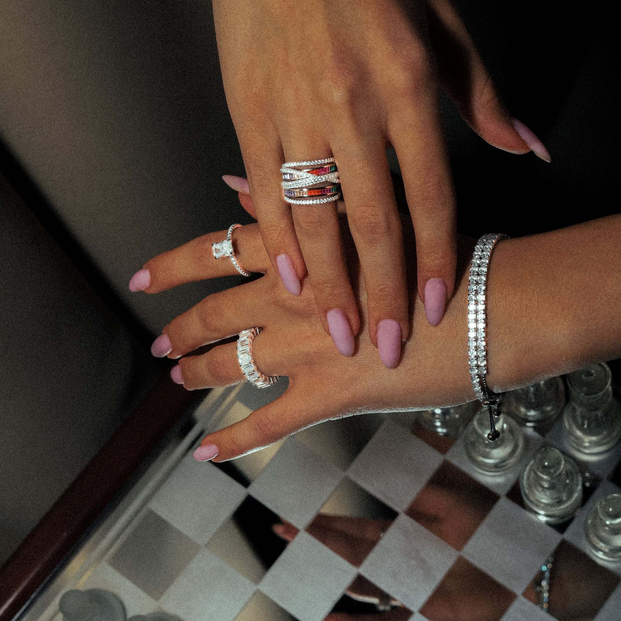 Crystal Garden Geometric Ring worn on finger, showcasing its stylish geometric design and radiant clear cubic zirconia stones, crafted from sterling silver with rhodium plating for a sophisticated appearance, combined with more stunning sterling silver rings