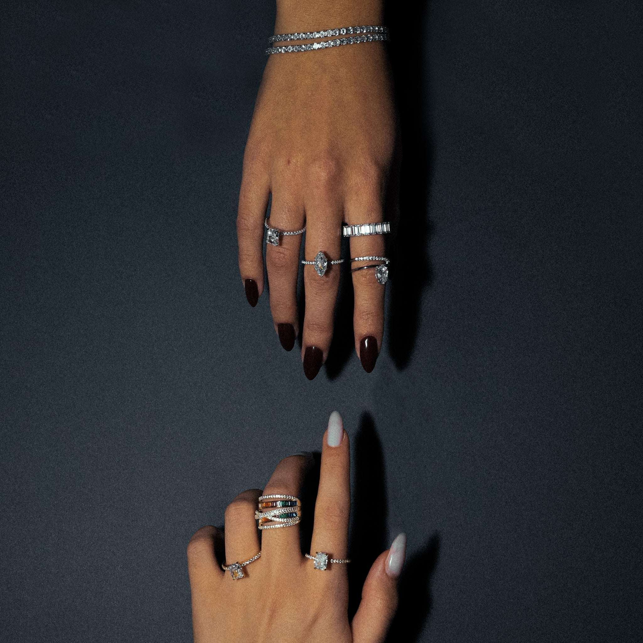 Kapi Rectangular Cut Ring in Gold, alongside other stunning jewelry pieces, showcasing the brilliant rectangular-cut center stone and pave cubic zirconia details set on a 925 sterling silver band with gold plating