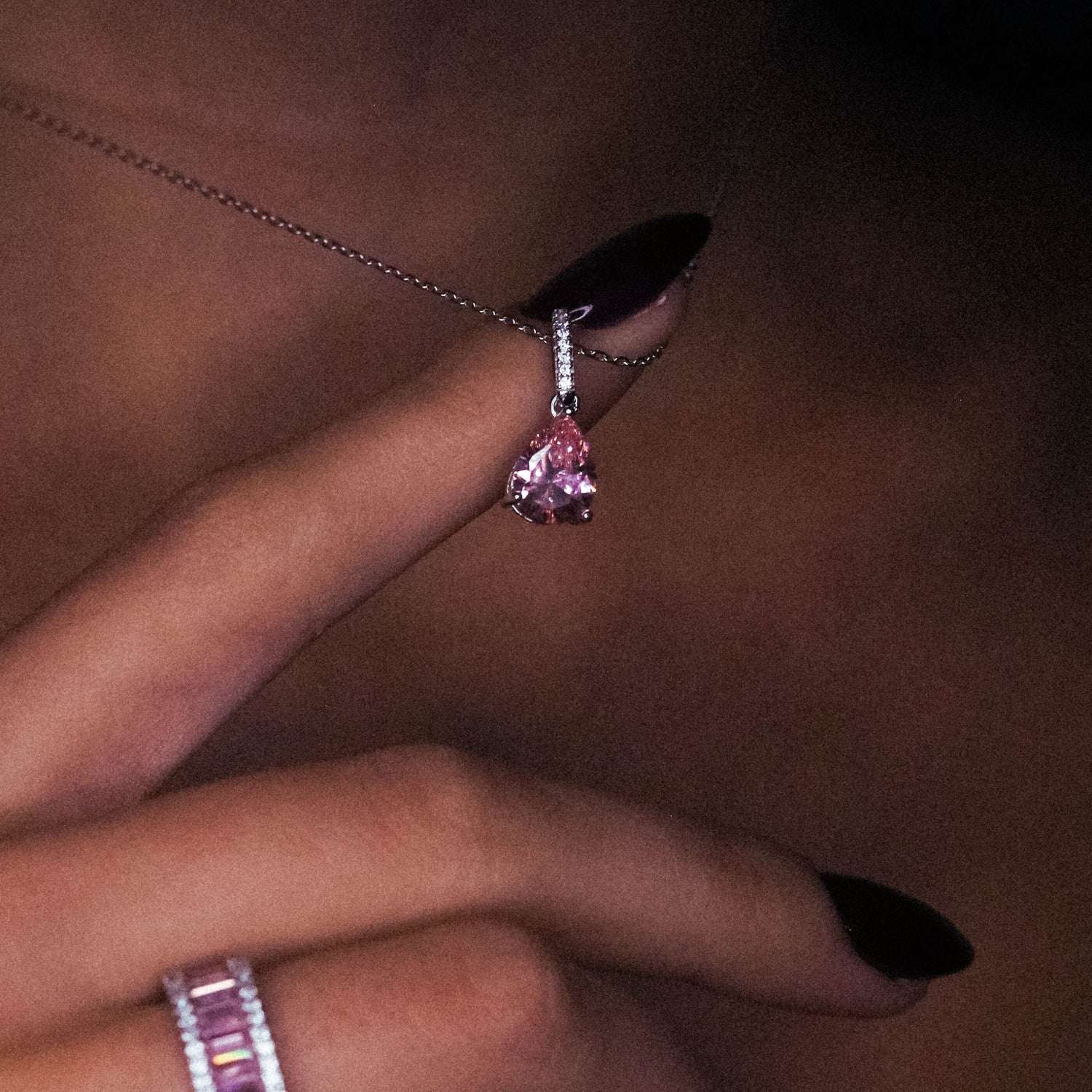 Lost Princess Necklace in Pink worn on neck, highlighting the vibrant pink gemstone pendant and chain, adding a royal touch to any outfit. Rhodium plated, made of 925 sterling silver
