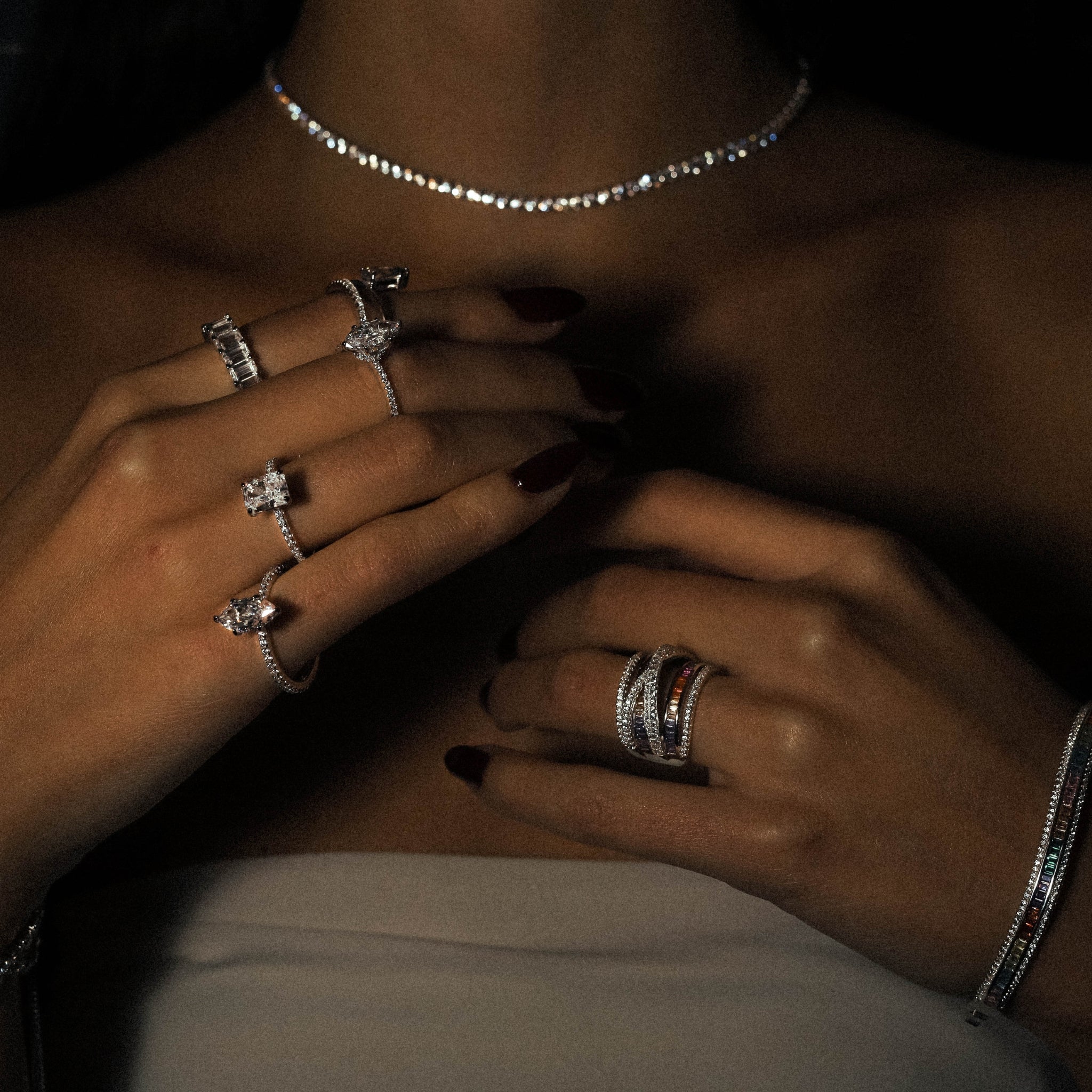 Kapi Rectangular Cut ring in sterling silver, rhodium plated, alongside an array of beautiful sterling silver rings, creating a beautiful and trendy image of a jewelry stack