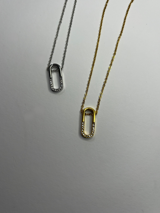 Stainless steel necklace in silver, long oval shape, half covered in white cubic zirconia. 18K gold plated neckalce  
