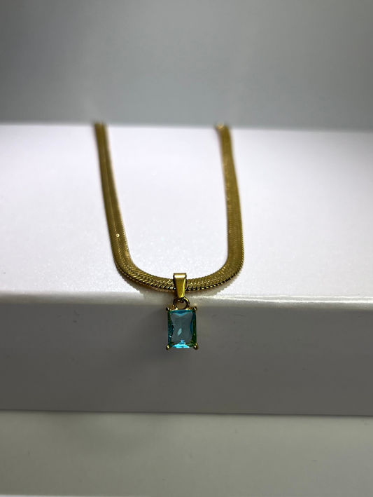 Stainless steel, 18K gold plated necklace with a snake chain, and a big, blue turquoise cubic zirconia stone  