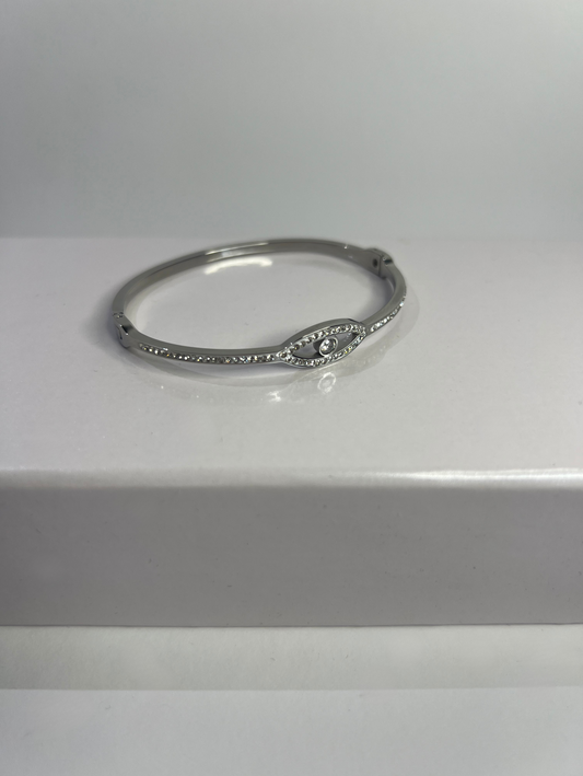 Stainless steel solid bracelet, in silver, with an eye, half covered in round, white cubic zirconia